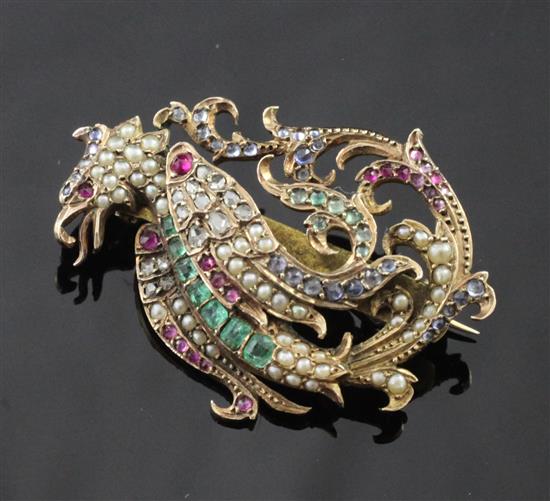 A late 19th/early 20th century gold and multi gem set brooch modelled as a Phoenix, 1.5in.